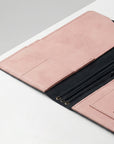 Pink leather wallet with black interior on a light gray background
