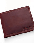 A dark reddish-brown leather bifold wallet with visible stitching and the brand name 'PIKORE' debossed on the bottom right, shown on a clean white background.