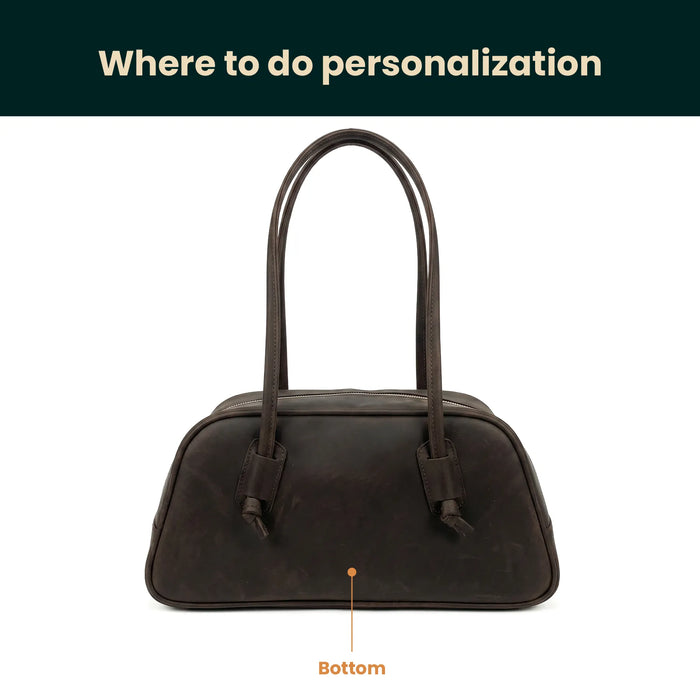 Brown handbag on a white background with text indicating where to do personalization.