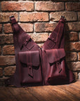 Two leather bags against a brick wall