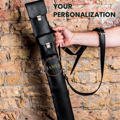 Black leather gun case with 'JAMES' branding held against a stone wall.