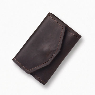 A dark brown leather card holder wallet with visible stitching and a fold-over flap, photographed on a clean white background.