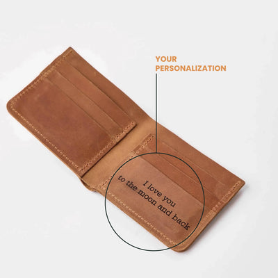 An open brown leather wallet on a light gray background, with text reading 'YOUR PERSONALIZATION' and a circle highlighting a printed message inside that says 'I love you to the moon and back'.