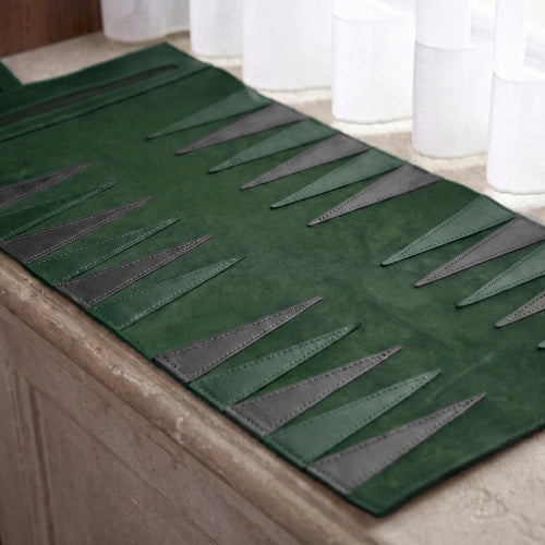 Green and gray textured rug on a wooden floor