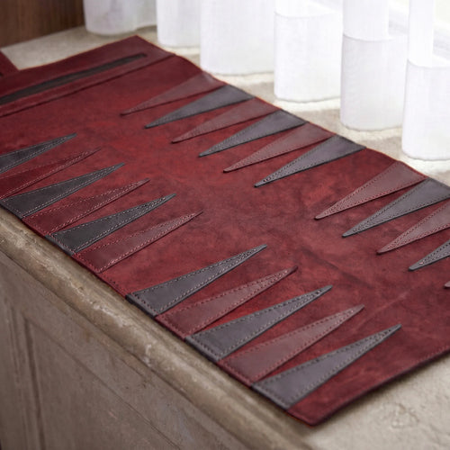 Red and gray patterned rug on a wooden floor