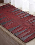 Red and gray patterned rug on a wooden floor