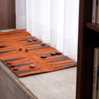 Backgammon board with pieces and dice on a wooden surface