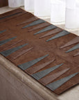 Brown and gray patterned rug on a wooden floor