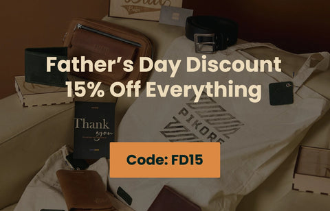 Collection of Father's Day gifts including a t-shirt, wallets, and a belt on a table with promotional text overlay.