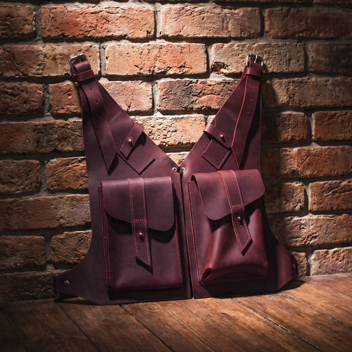 Two leather bags against a brick wall